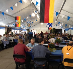 People at Oktoberfest Tool Show sitting under German flags